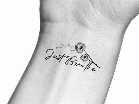 A Dandelion Tattoo With The Words Just Breathe On It