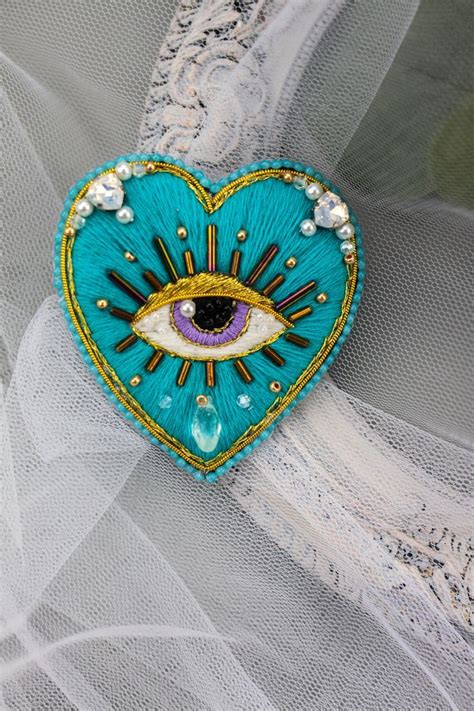 A Heart Shaped Brooch With An Eye On It