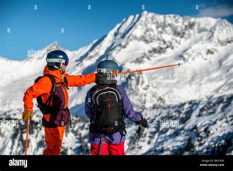 A Male Ski Instructor Teaches A Woman In The French Alpine Resort Of