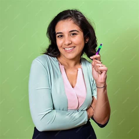 Premium Ai Image A Woman Holding A Pen In Her Hand And A Green Background