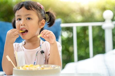 Premium Photo Portrait Of A Boy Eating Food
