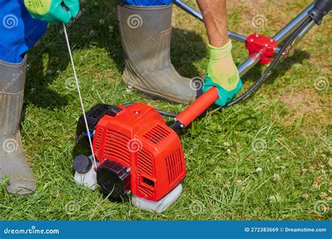 Starting A Brushcutter Man Pulls The Cord To Start The Brush Cutter