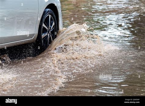 Car Passing Through A Flooded Road Driving Car On Flooded Road During