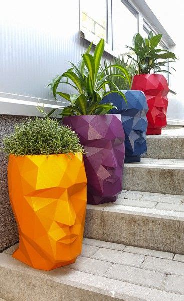 Three Planters With Plants In Them Sitting On The Steps