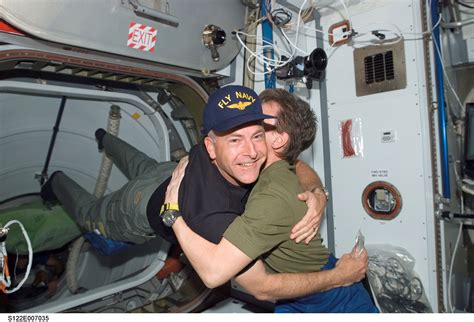 Astronauts Floating Hugging Astronaut Captain Hat Photo