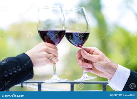 Hands Holding Red Wine Glasses To Clink Stock Image Image Of