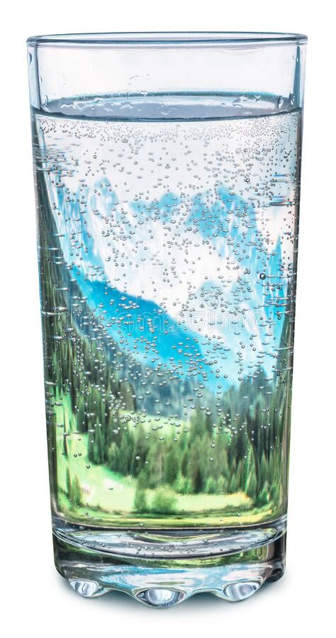 Glass Of Water With Snow Mountains Tops And Green Forests Inside As A