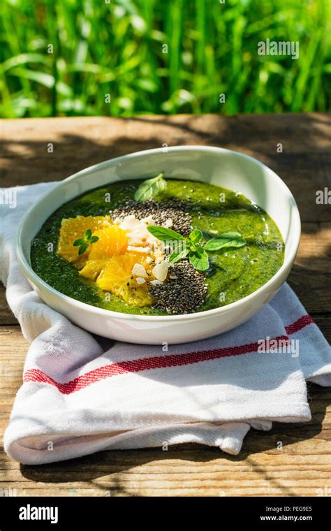 Green Smoothie Bowl With Banana Spinach Chia Seeds And Oranges Stock