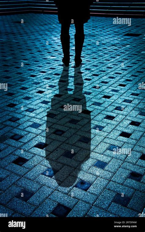 Mysterious Woman In Black Coat And Boots With Shadow Stock Photo Alamy