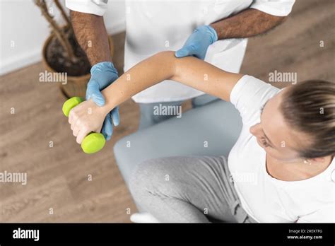 High Angle Male Physiotherapist Checking Woman S Strength Resolution