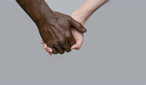 Black Male And White Female Human Hands Touch Palms Holding Each Other