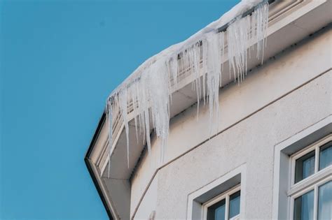 Premium Photo Icicles Hanging From The Edge Of Roof