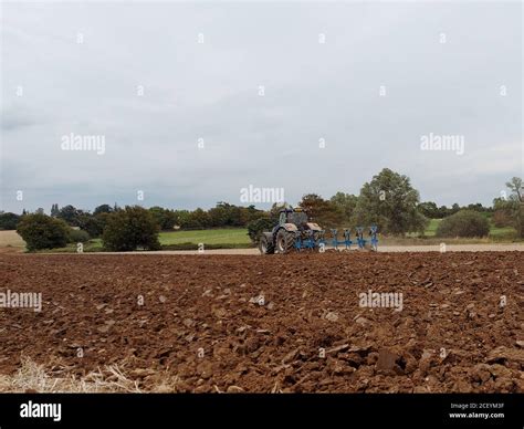 Farmer ploughing a field Stock Photo - Alamy