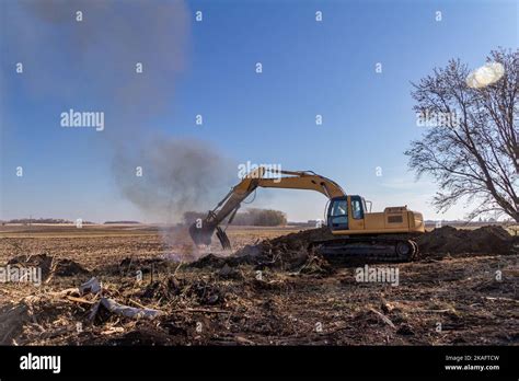 Close Up View Of A Heavy Equipment Excavator Moving Trees And Wooden