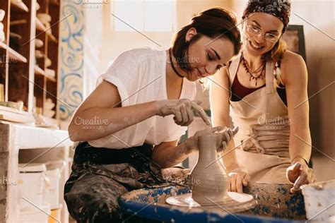 Two Women At A Pottery Workshop Featuring Apron Artist And Business Pottery Workshop