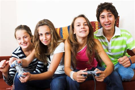 Four teenagers playing video games together - Bellingham Public Library