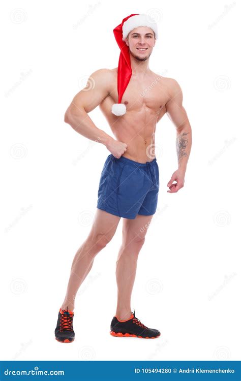 Guy With Naked Torso And Santa Hat Smiling And Posing Showing Off His