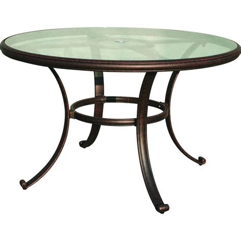 A Round Glass Table With Metal Legs And An Iron Frame Around The Top Against A White Background