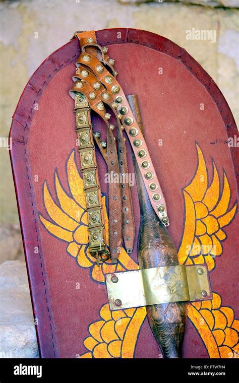 Close Up Of Decorated Roman Scutum Shield And Studded Belt With Red And