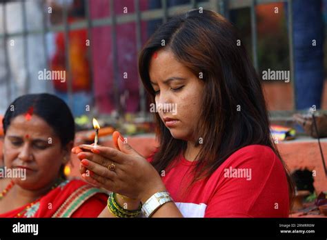 A Woman Prays With Lighting Butter Lamp While Offering Her Prayers