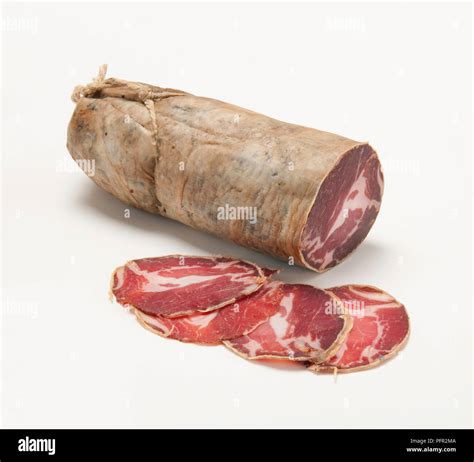 Whole And Sliced Italian Capocollo Dry Cured Pork Sausage Stock Photo