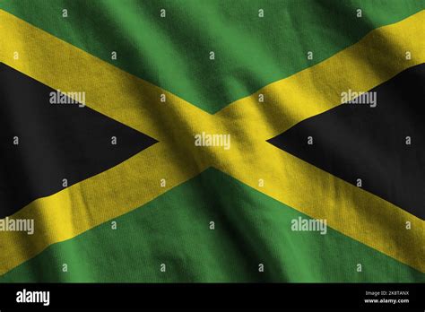 Jamaica Flag With Big Folds Waving Close Up Under The Studio Light