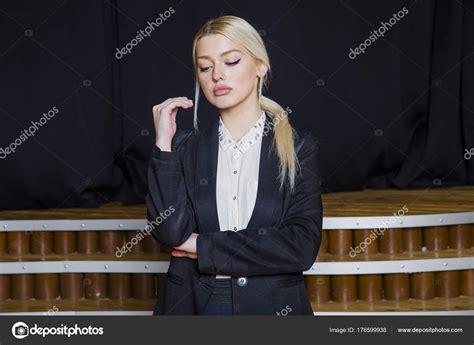Beautiful Blonde Businesswoman With Puffy Lips At Loft Office In Suit