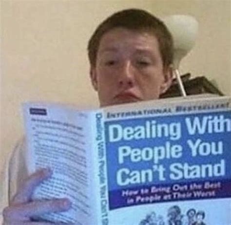 A Man Is Reading A Book While Wearing A Cowboy Hat And Holding It Up To