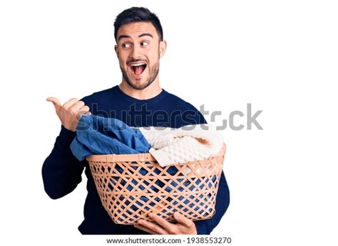 Young Handsome Man Holding Laundry Basket Stock Photo 1938553270