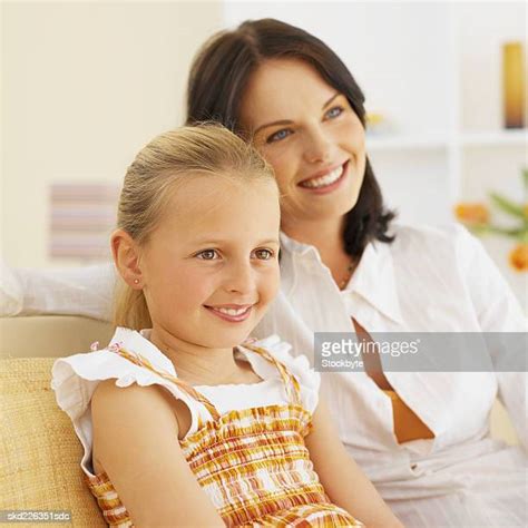 517 Parents With Children 2 7 Sitting On Sofa Smiling Portrait Stock