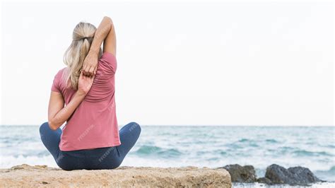 Premium Photo Pretty Blonde Woman Stretching At The Beach