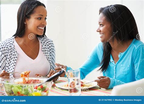 Two Women Eating Meal Together At Home Stock Photo Image Of Indoors