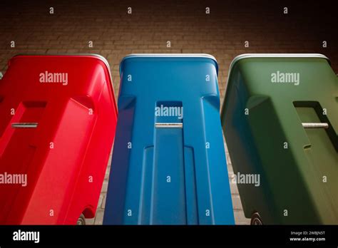 A Lineup Of Vibrantly Hued Red Blue And Green Recycling Bins With