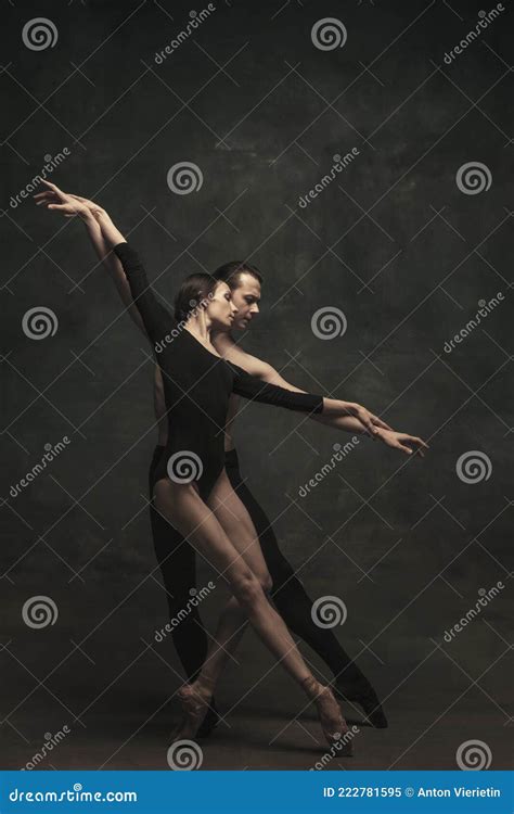 Beautiful Graceful Woman And Man Ballet Dancers In Art Performance Dancing Over Dark Background