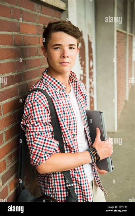 Teenage Boy Leaning Against Brick Wall Stock Photo Alamy