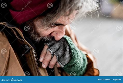 A Close Up View Of Homeless Beggar Man Standing Outdoors In City Stock