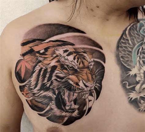 A Man With Tattoos On His Chest Has A Tiger And Dragon Tattoo On His Chest