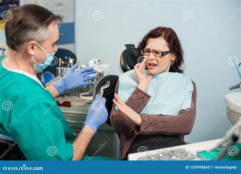 The Dentist With The Help Of A Carpule Syringe Injects Anesthesia Into