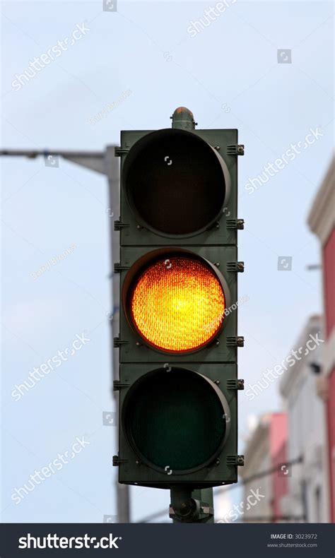 An Amber Caution Light On A Traffic Signal Stock Photo 3023972