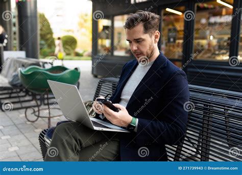 Portrait Of A Confident European Businessman Holding A Laptop In His