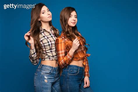 Two Slim Sisters In Checkered Shirts And Jeans Posing 이미지 1372006856