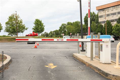 parking lot gate, a barrier depicting control, access restriction, transition, and urban ...