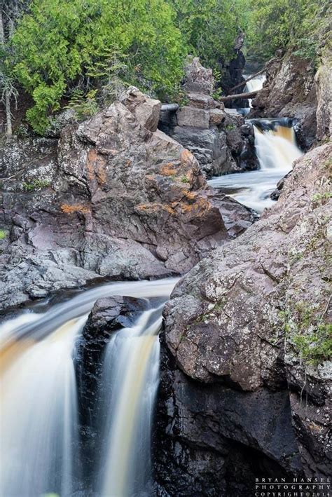 a small waterfall flowing down rocks into a river