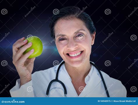 Female Doctor With Apple Against Blue Flare Stock Image Image Of