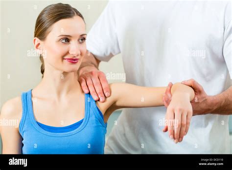 Female Patient At The Physiotherapy Doing Physical Exercises With Her