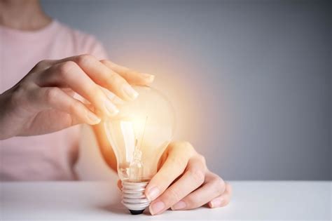 Premium Photo Business Women Hand Holding Light Bulb Concept Of New