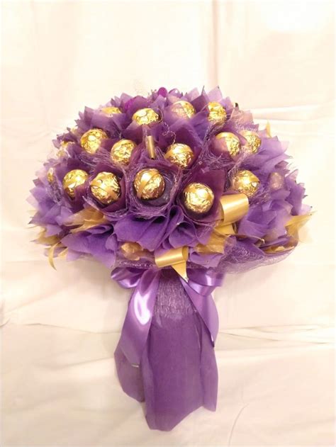 A Bouquet Of Chocolates Wrapped In Purple Ribbon