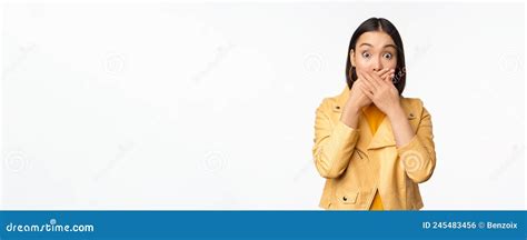 Image Of Shocked Asian Girl Shuts Mouth Close Lips And Looking