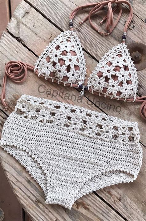 Two White Crochet Bikinis On Top Of A Wooden Table