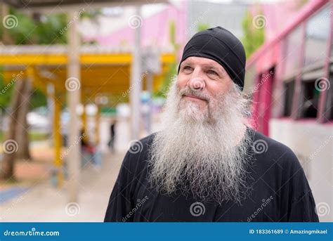 Face Of Mature Handsome Bearded Hipster Man Thinking At The Bus Stop